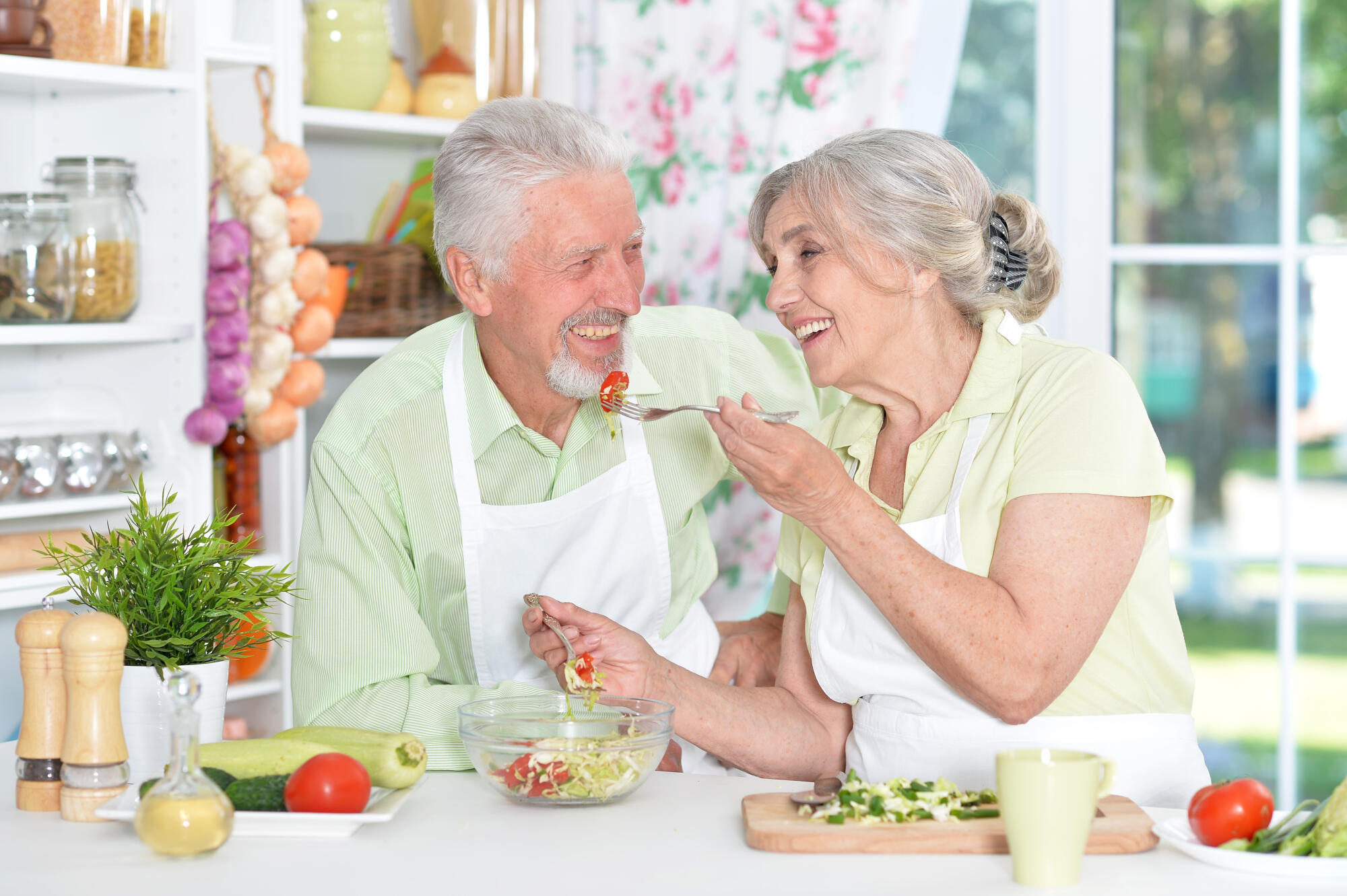 Portrait of a senior couple cooking in kitchen